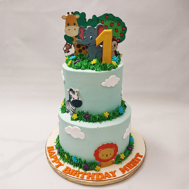 A zebra proudly displays its striking black and white stripes, and mischievous monkeys swing from branch to branch, adding an element of playful charm to this animal birthday cake for kids.