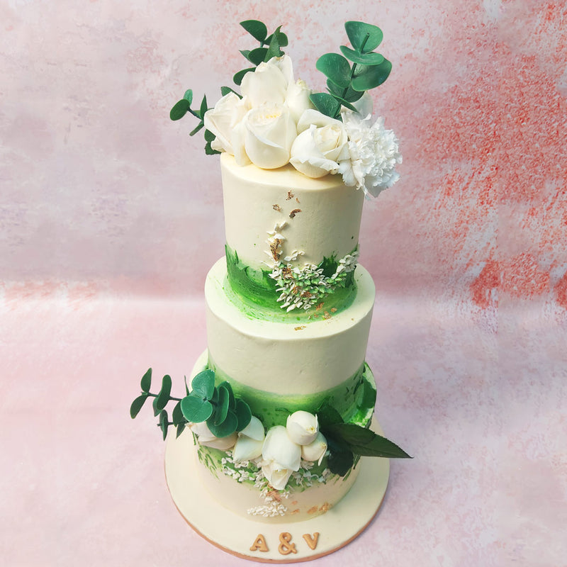 The intricate painting on this Three Tier Bouquet Cake creates a captivating canopy of leaves or a verdant bed of grass.