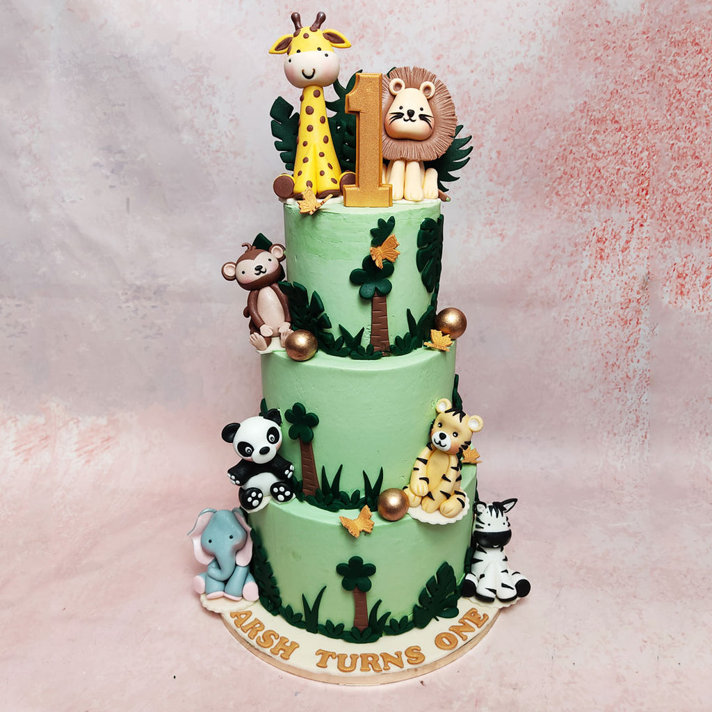 Step into the wild with our 3 Tier Jungle Theme Cake! Picture a verdant canvas, adorned with tropical leaves and playful palm trees. 