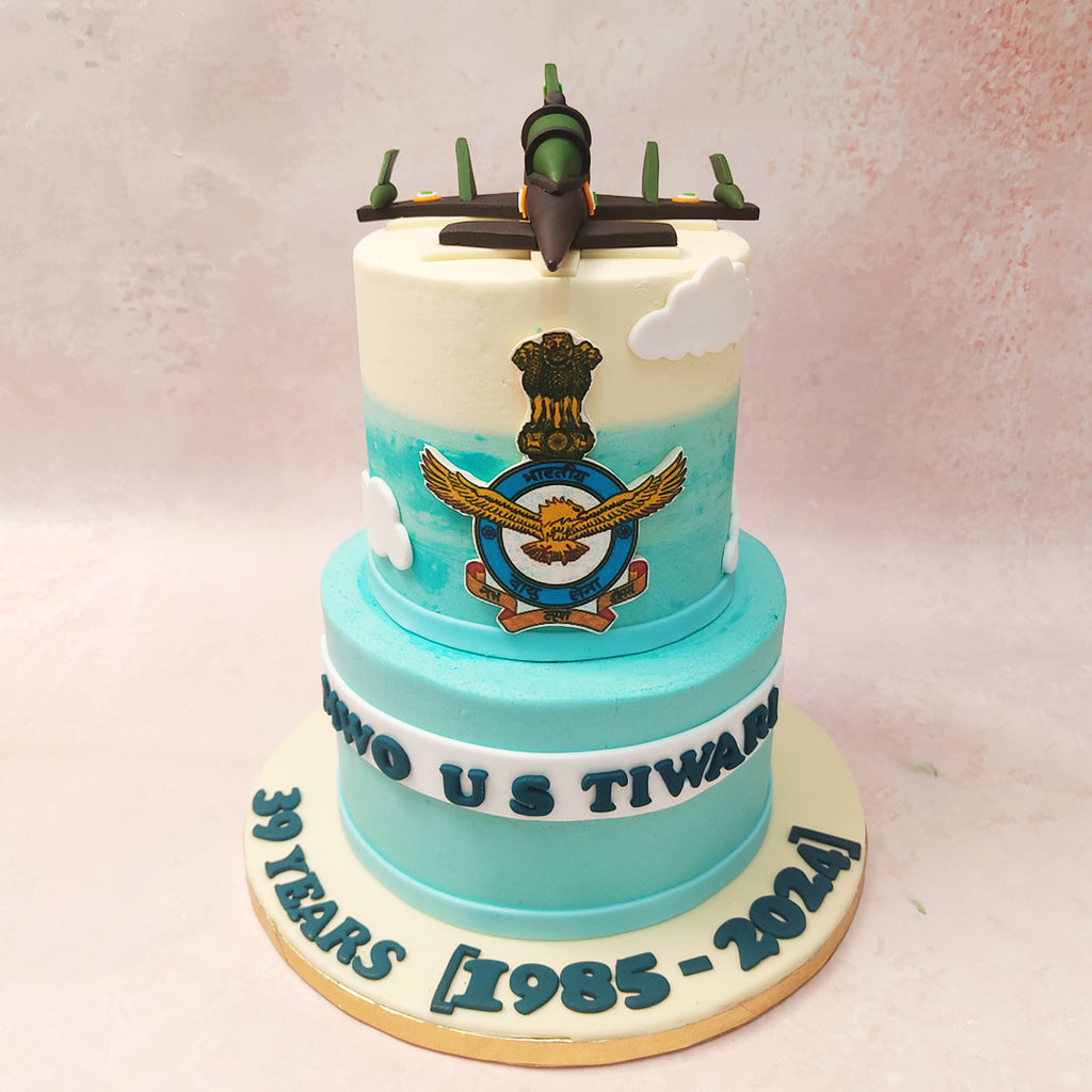 With a sky-blue base representing the vast expanse of the heavens, and a seamless ombre transition from blue to white atop the second tier, this Air Force Retirement Cake captures the essence of the sky, where every pilot's journey begins and ends. 