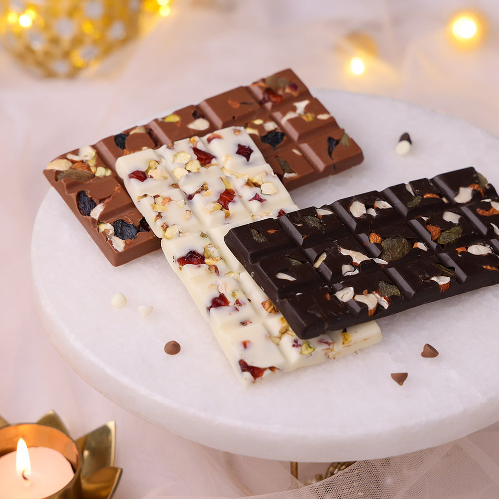 An assortment of dark, milk, and white Diwali chocolate bars with dry fruits and nuts