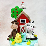 This Animal Countryside Cake showcases an adorable cast of characters, with a red barn feature taking centre stage. 