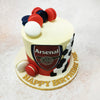 One of the standout elements of this Arsenal FC Cake is the cascade of hexagonal black-and-white fondant shapes down one side, resembling a classic football pattern. 