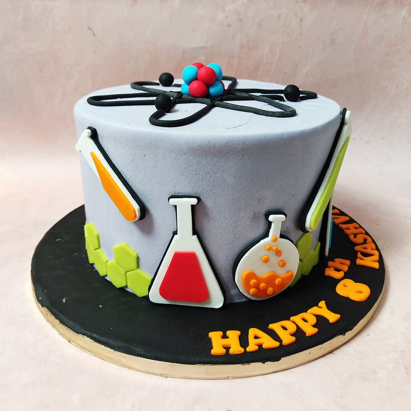 Witness the bubbling cauldron of excitement that is this Chemistry Cake design, where green hexagons align like molecules in a symphony of scientific artistry at the bottom and a light bulb illuminates the creative brilliance.