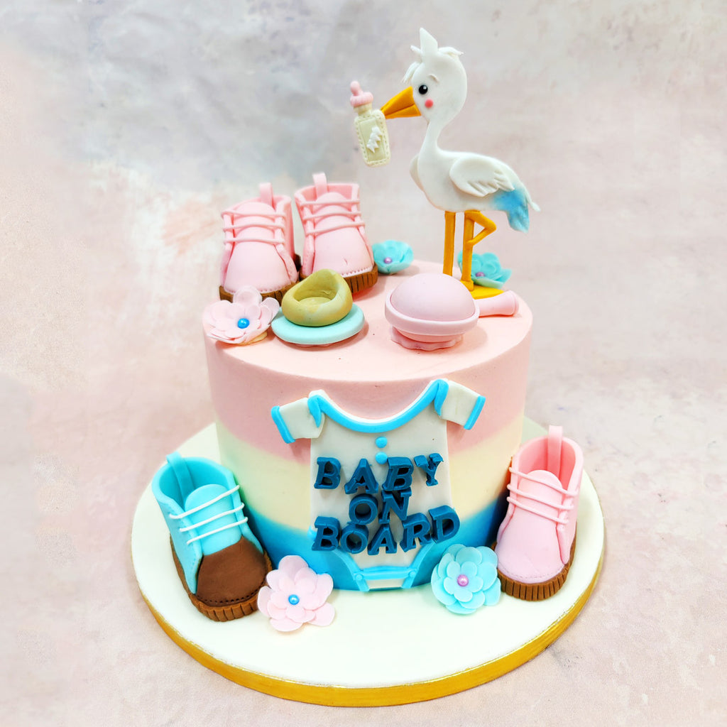 This Baby On Board Cake captures the joy of a growing family with a charmingly playful design. 