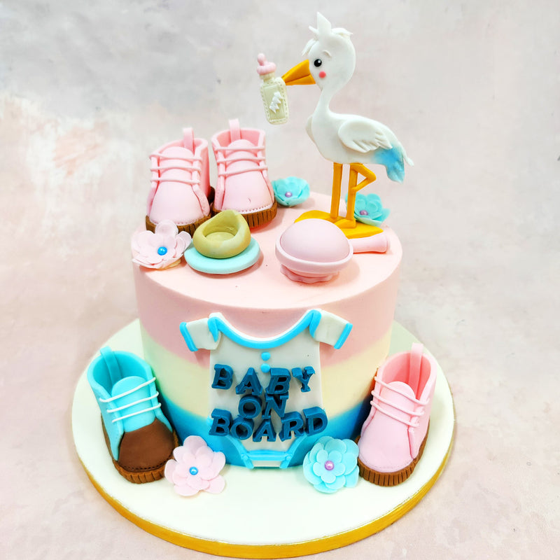 From its soft pastel hues to the central onesie that reads “Baby On Board,” every element is crafted to celebrate new beginnings. It’s the perfect centrepiece for any joyful Baby Shower Cake moment.