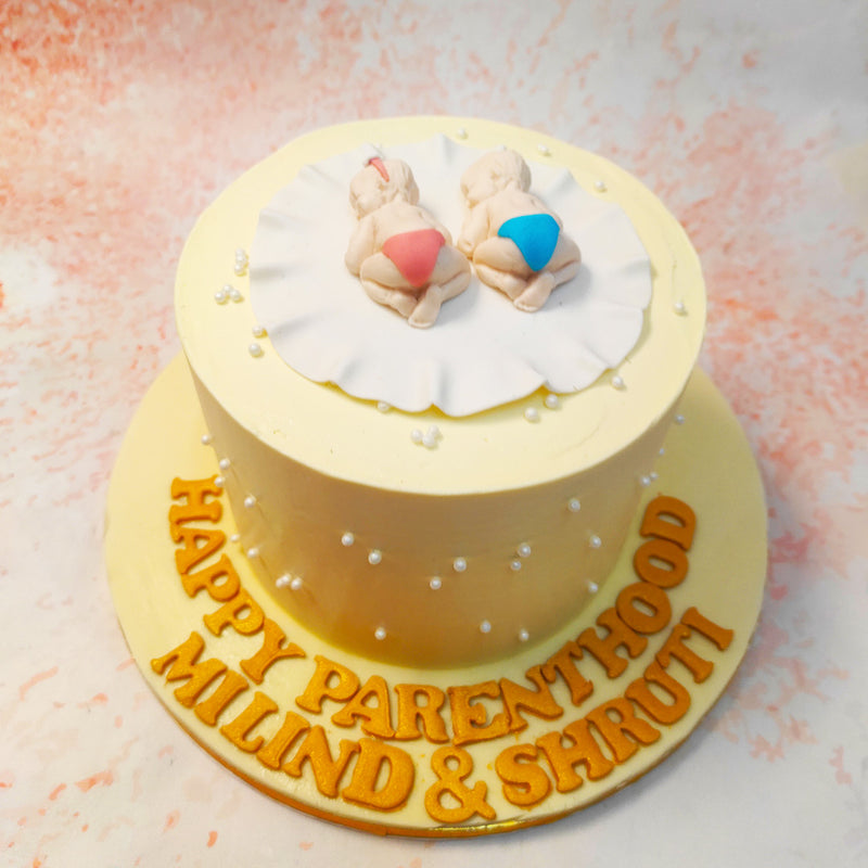 This Twins Cake, adorned with exquisite detail, features two adorable sleeping babies, each nestled peacefully on a delicate white blanket. 