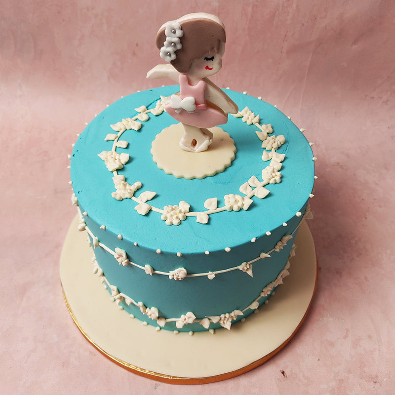 The captivating and cute ballerina figurine on top, dressed in a charming pink frock, becomes the star of this Ballerina Cake