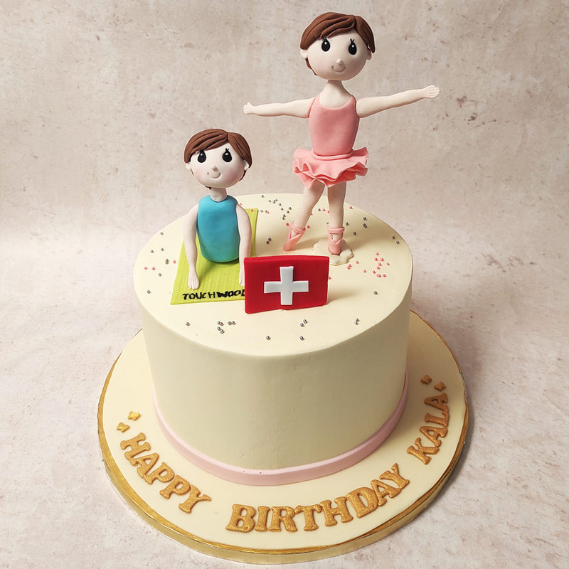 Next to the ballerina is a woman deep in yoga poses, a symbol of serenity and inner peace. Their juxtaposition on this fitness cake for women is a playful nod to the harmony between strength and flexibility, discipline and tranquillity, ballet and yoga.