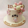 With a neutral to pastel pink tone setting the background of this balloons theme cake, the figurine of a little girl with pigtails and a little pink and white frock can be seen on the circumference holding up a host of edible balloons. 