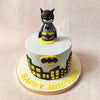 At the heart of this Batman Birthday Cake For Kids lies the iconic Batman logo – a beacon of justice amidst the dark frosting.   Perched atop this Batman Cartoon Cake, a miniature Dark Knight, ready for action, adds an air of suspense, like a keychain guardian watching over Gotham's sugary secrets.