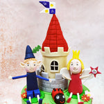 Standing proudly on this Ben and Holly’s Castle Cake between the characters is their iconic castle tower, complete with cream-coloured walls and a distinctive red spire. 