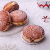 Sugar-coated berliners on a white plate with a christmas background