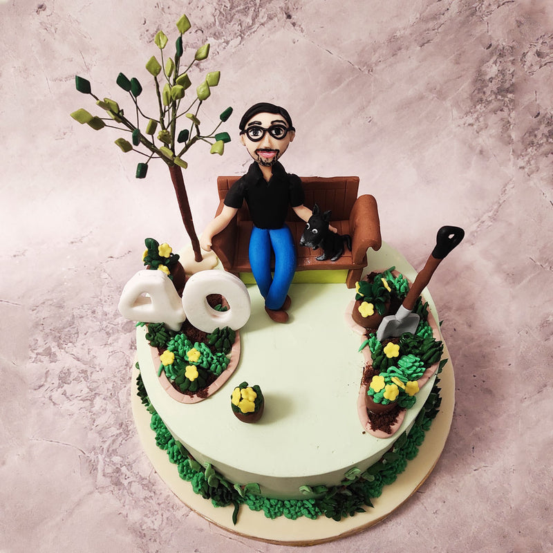 At the centre of this dad theme cake is an edible figurine of a father sitting on a bench beside a majestic tree. 