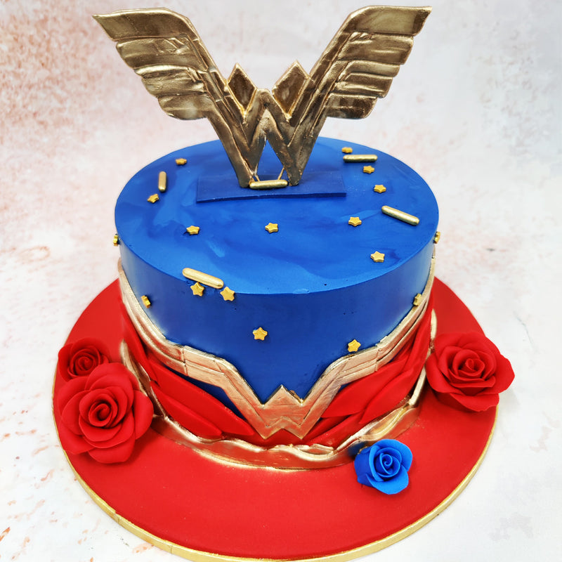 Beautiful handcrafted roses in vibrant red and a singular blue rose add an elegant touch to this Wonder Woman Theme Cake.