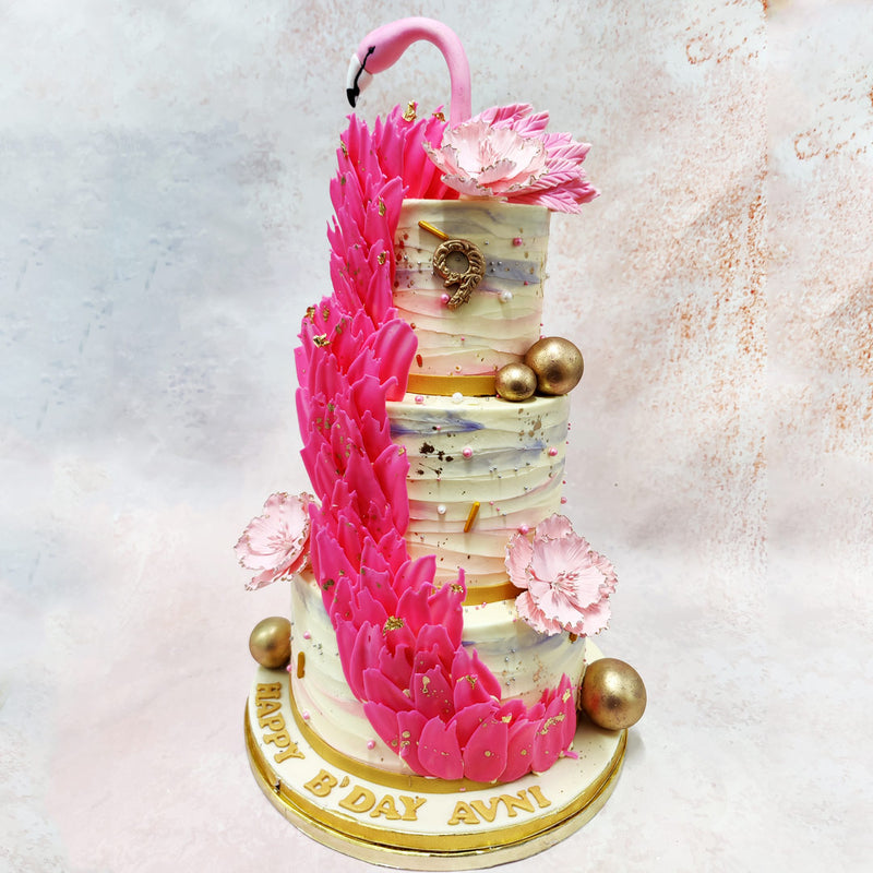 The blush pink feathers are adorned with edible gold accents, giving this Birthday Cake For Her a luxurious touch, reminiscent of the majestic bird’s exotic allure. 