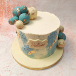 This Artsy Cake design, adorned with a medley of turquoise and white chocolate spheres, is an ode to refined artistry. 