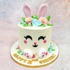 What makes this Birthday Cake For Kids especially delightful is the full bunny-face transformation: tiny edible paws at the base, a soft vanilla canvas for the fur, and dainty sugar flowers nestled all around. 