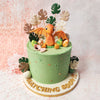 This Baby Dino Cake is expertly crafted with a smooth green icing base, adorned with subtle golden accents that add a touch of magic and elegance. 