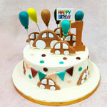 Around the sides of this Birthday Cake For Kids, more toy cars cruise along the buttercream “track,” weaving between triangle bunting flags and bright confetti dots in teal, rust, peach, and chocolate. 