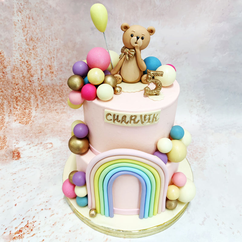 Surrounding the bear are balloon-like spheres in soft pastel shades of pink, purple, yellow, and gold, creating a celebratory feel with a touch of elegance to this Birthday Cake For Kids.