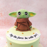 Atop this Star Wars Cake sits an incredibly detailed figure of Grogu, also known as Baby Yoda, with his big, expressive eyes and endearing features. 