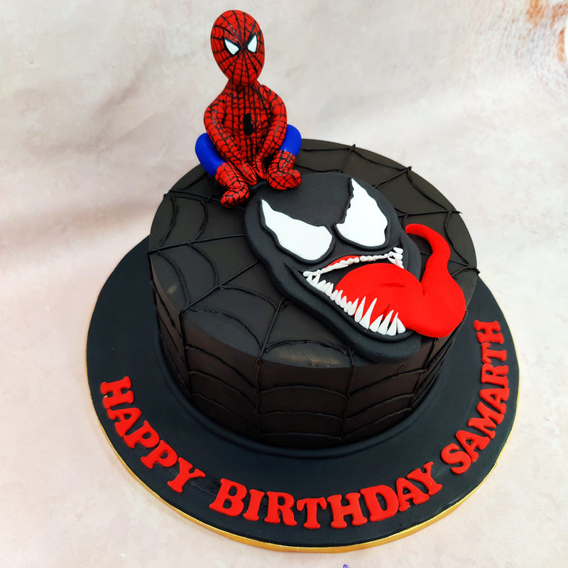 Perched atop this Birthday Cake For Kids is a remarkably detailed fondant figurine of Spider-Man himself, depicted in his classic red and blue suit complete with the signature webbed pattern. 