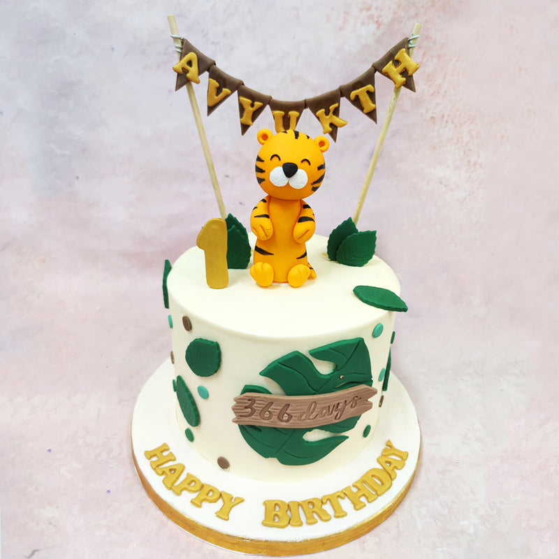 The character sits amidst oversized green leaves that echo a rainforest motif, lending the Birthday Cake For Kids an adventurous, safari-like charm right from the start.