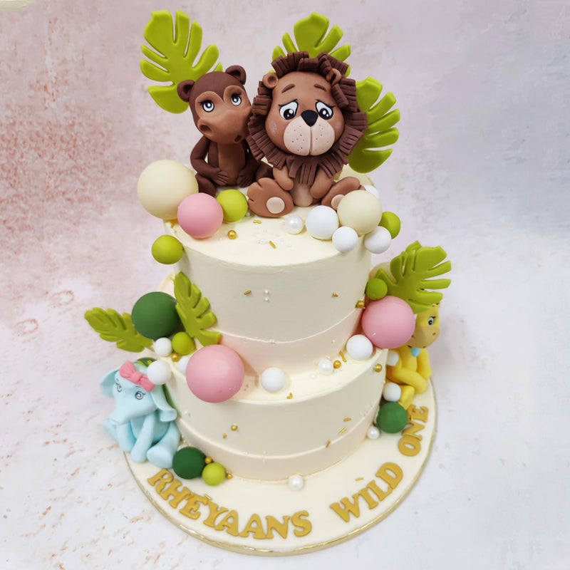 Scattered throughout this Jungle Theme Birthday Cake For Kids are perfectly rounded baubles in soft pastel pink, fresh green, and pearl white, adding a contemporary touch to the safari theme. 