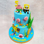 SpongeBob and Patrick sit grinning on the top tier, their sculpted expressions full of goofy charm. Around the cake, you’ll find jellyfish with dangling tentacles, underwater plants, Gary the snail, and even a mini pineapple door—all adding to the immersive, underwater world of this Birthday Cake For Kids.