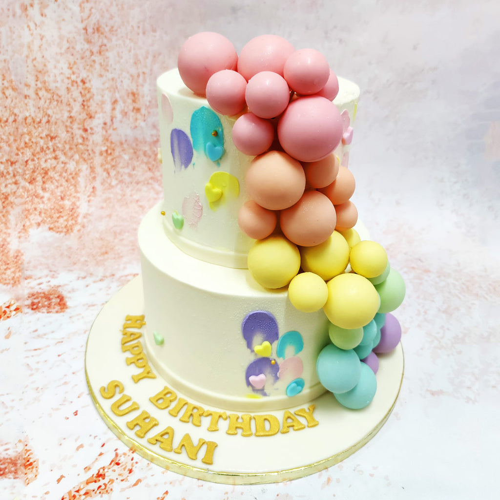 Small, edible hearts and splashes of pastel hues further enhance the charm of this Birthday Cake For Kids, adding a layer of playful elegance. 