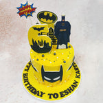 Surrounding the central Batman motif are a scattering of metallic spheres in shades of gold and grey, evoking the sleek, high-tech aesthetic of the Dark Knight's gadgets and equipment on this Birthday Cake For Kids. 