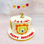 Above the lion’s crown, a miniature golden number and a string of flags in alternating red and yellow dance in celebration, giving this Birthday Cake For Kids a circus-meets-safari charm. 
