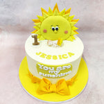 Set against a pristine white background, this Birthday Cake For Kids showcases meticulous attention to detail with a delicate sleeping baby figurine, symbolising the peaceful slumber of infancy beneath the watchful gaze of the sunshine. 