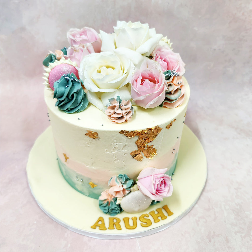 The centrepiece of this Birthday Cake For Wife showcases exquisitely crafted roses in varying sizes, from pure white garden roses to the softest pink blooms, each petal meticulously shaped to capture nature's perfection.