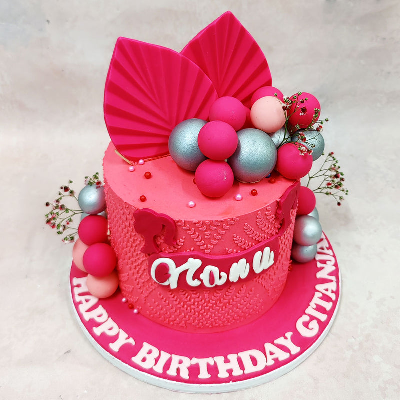 What makes this Birthday Cake For Women stand out is the texture: delicate embossed patterns sweep across the vibrant pink base like stitched lace, creating visual interest without overwhelming the eye. 