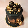 What sets this elegant black and gold cake apart is the meticulous placement of baubles, carefully arranged to resemble precious jewels. Each bauble is delicately handcrafted and adds a touch of opulence to the overall design. 