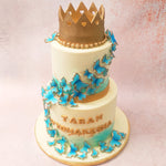  Two tiers of scrumptious, blue and gold cake, the aesthetic of this butterfly theme birthday cake for girls is that of royalty and elegance.