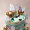 Accompanying them are large gold baubles, representing the precious moments shared with your girlfriend on this blue butterfly theme cake