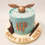 The blue colour of the base of this Snitch and wand cake symbolises loyalty, wisdom, and intelligence - traits that are highly valued in the wizarding world and represents the house of Ravenclaw, known for its cleverness and wit. 