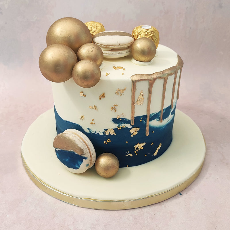 With an array of macarons and Ferrero Rocher chocolates on top, this blue ombre cake also creates the appearance of a dessert platter. If there's someone in your life who deserves nothing but the best but is too illimitable to be paid homage to in just one design, this blue and gold drip cake would make her perfect birthday cake for him / birthday cake for her.