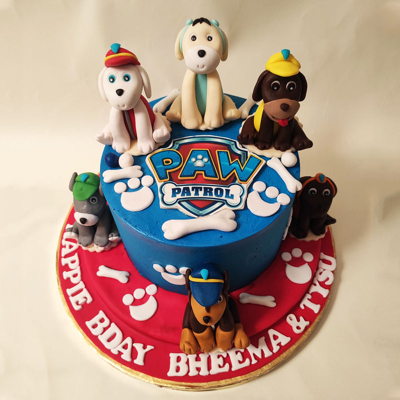 At the centre of this  Rubble birthday cake for kids, you'll find the iconic Paw Patrol logo, proudly displayed as a beacon of hope and adventure. Surrounding it are figurines of all six puppies.