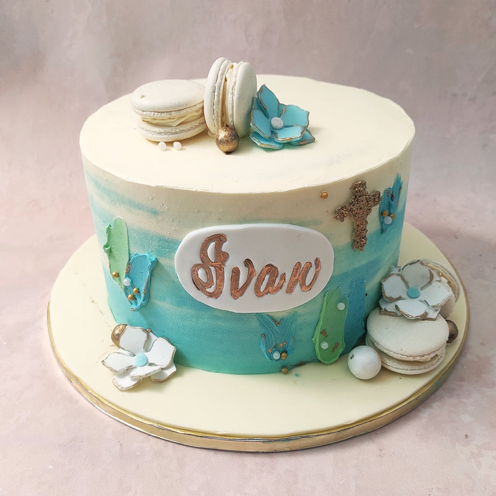 The edible floral decor on this sea themed baptism cake symbolises the beauty and growth that comes with embracing faith.