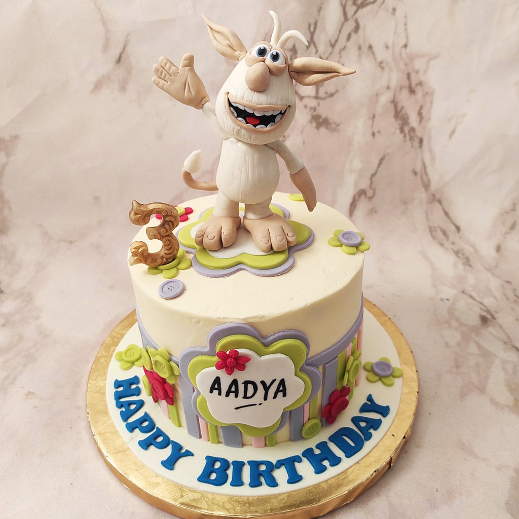 Adorned with green and blue stripes, reminiscent of the playful nature of Booba's adventures, and featuring green and red buttons that pay homage to his mischievous antics, this Booba cartoon cake truly captures the essence of the show.