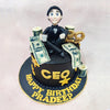 Sitting atop this Boss Cake is a charming figurine of a businessman in formal attire, complete with a black tuxedo and bow tie, holding what appears to be a coffee cup—the quintessential companion of any dedicated professional. 