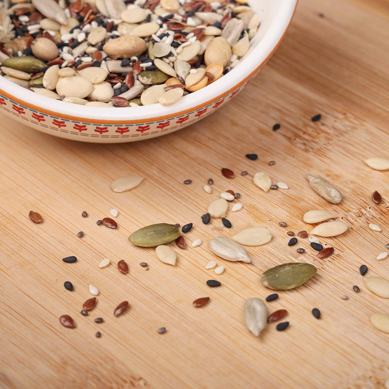 Bowl filled with various raw seeds for a trail mix, including pumpkin, sunflower, and chia seeds