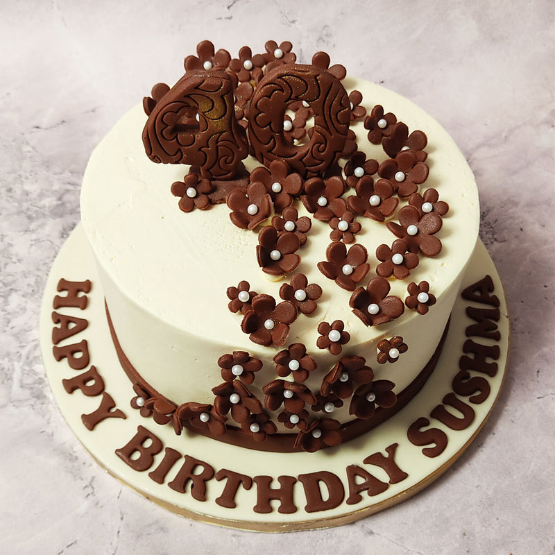 This brown and white floral cake is adorned with brown sugar flowers, embedded with pearls at the centre, cascade from top to bottom, each meticulously handcrafted to perfection. 