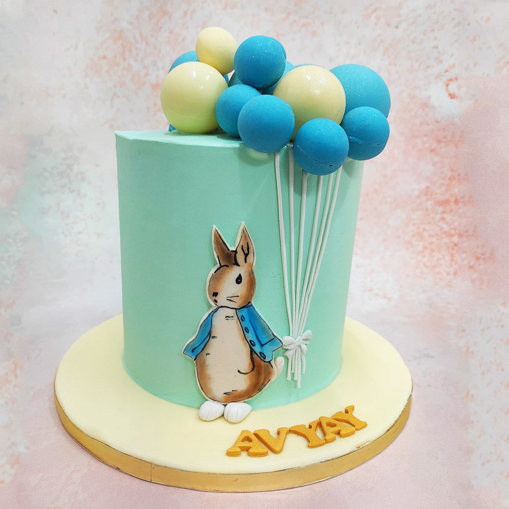 At its peak, Peter Rabbit, the charming bunny donned in white shoes and a denim jacket captures the essence of childhood adventure on this Bunny With Balloons Cake design.