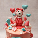 Dressed in a charming pink frock and donning a bow on its head, the teddy bear topper of this birthday cake for girls exudes a sense of warmth and companionship.