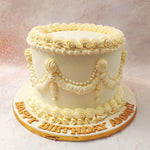 The smooth, ivory buttercream base provides a pristine canvas for the elaborate lacework that adorns this White Vintage Cake. 